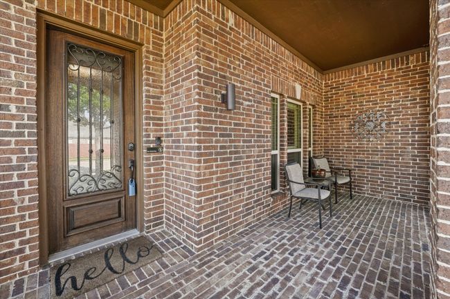 View of exterior entry featuring brick siding | Image 5