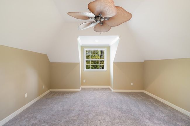 Bonus room featuring ceiling fan, lofted ceiling, baseboards, and carpet | Image 24