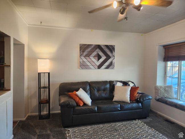 Spacious living room with ceiling fan and large front window/bench seat | Image 13