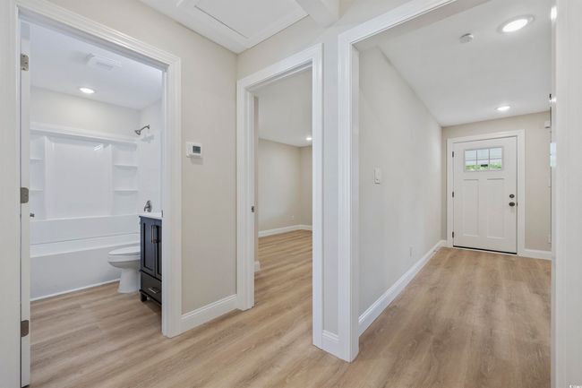 Corridor with light wood-type flooring, baseboards, and recessed lighting | Image 17