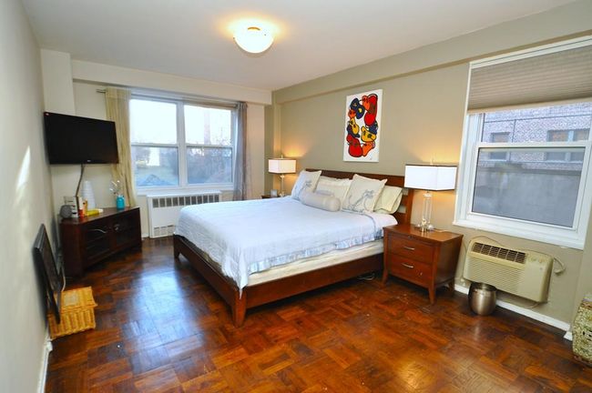 Large Bedroom can accommodate a king size bed, dresser, end tables and reading chair. The room also has parquet floors. | Image 16