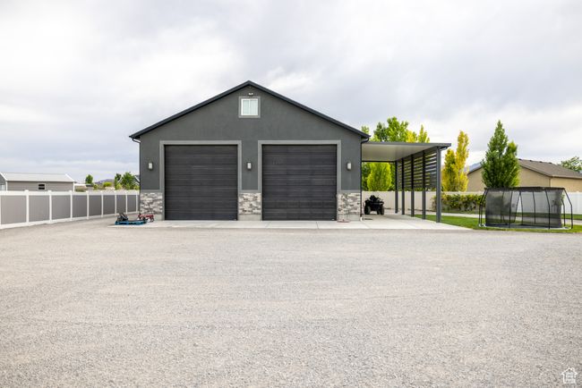 Garage featuring a trampoline and a detached garage | Image 82