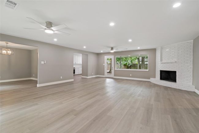 3rd view from entry of the breakfast room and the large living/family area with a fireplace and overlooking the backyard. | Image 20