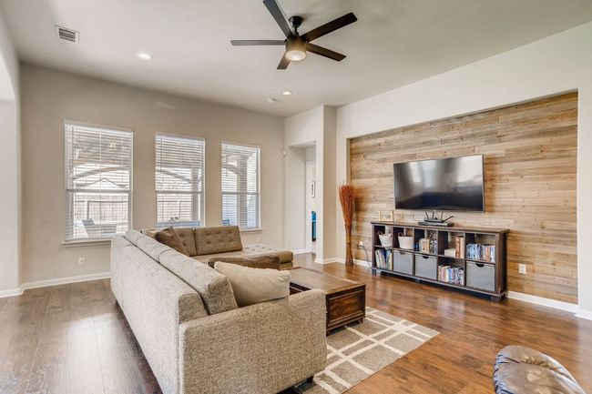 Living room with ceiling fan, wood finished floors, and recessed lighting | Image 13