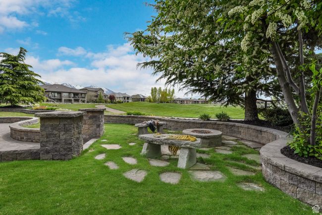 View of yard featuring an outdoor fire pit and a residential view | Image 31