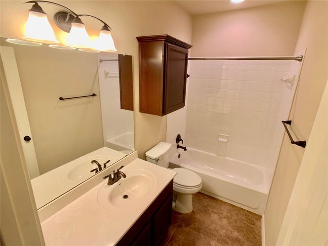 Bathroom featuring toilet, vanity, shower / bath combination, and tile patterned floors | Image 12