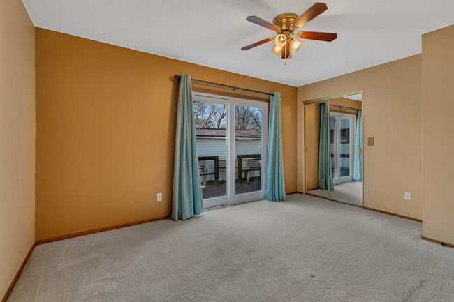 Main Floor Primary/Owner's Bedroom with walk-through Bathroom, walk-in closet, skylight and sliding glass door to deck | Image 14