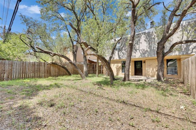Spacious private backyard with lots of live oak trees. | Image 14