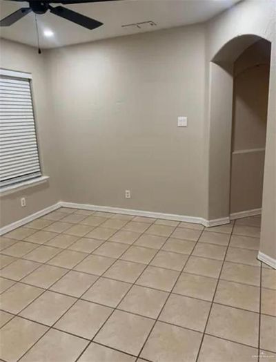 Tiled empty room with ceiling fan | Image 3