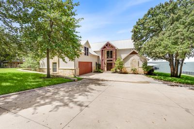 151 Stockton Point..the epitome of lakeside living. Gorgeous home, framed with mature shade trees leading to open water views! | Image 1