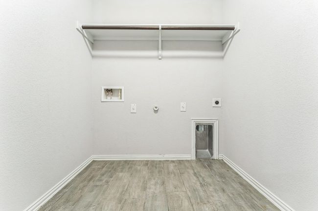Laundry room with gas dryer hookup, hookup for an electric dryer, wood finished floors, and hookup for a washing machine | Image 13