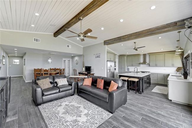 Living room featuring a ceiling fan, wood finished floors, recessed lighting, and baseboards | Image 8