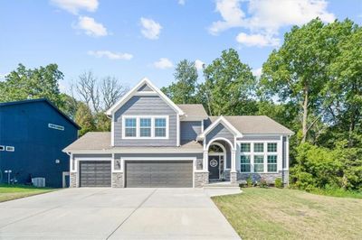 Craftsman house featuring a garage and a front lawn | Image 1