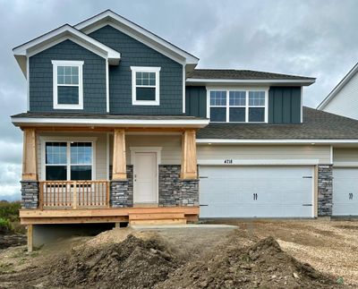 Beautiful exterior on the Redwood floor plan. Pillars and railing will be painted white. Asphalt driveway coming soon along with a fully sodded yard, mulch edging, and irrigation throughout. | Image 1