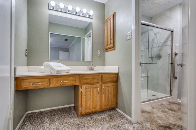 Bathroom featuring a shower stall and vanity | Image 16