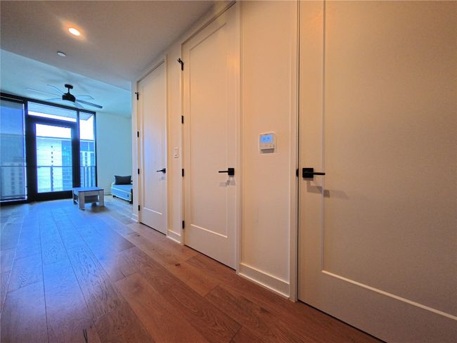 Hallway with wood finished floors and recessed lighting | Image 4