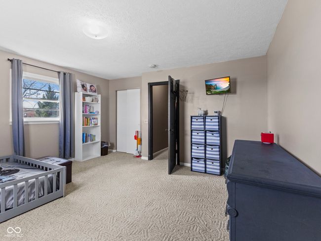 carpeted bedroom with baseboards and a textured ceiling | Image 27