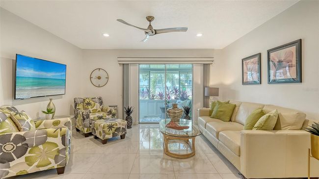 Spacious layout with abundant natural light and sliding glass doors. | Image 6