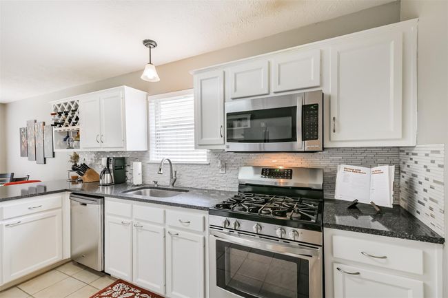 You'll love cooking with the updated appliances and pull-down sprayer faucet in the oversized single basin kitchen sink. | Image 7