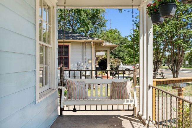 Imagine sipping a drink with a friend on your most adorable front porch swing. Welcome home! | Image 17
