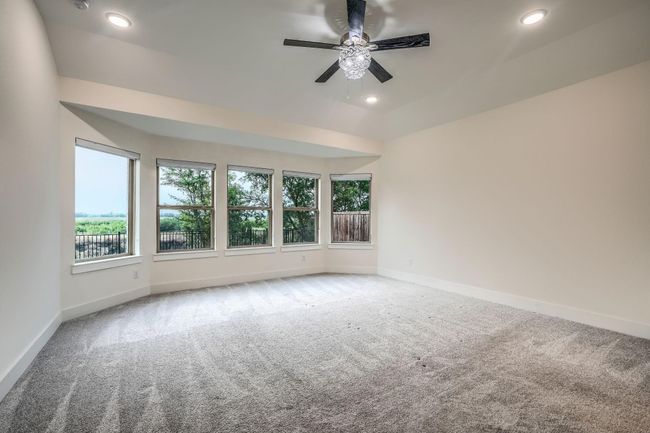 Carpeted empty room featuring plenty of natural light, a ceiling fan, recessed lighting, and baseboards | Image 18