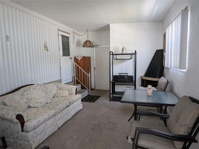 Bonus room provides an additional 811 sq ft of living space. Shed is located straight ahead and back door entry (to hallway leading to kitchen and primary bedroom) is on left. | Image 3