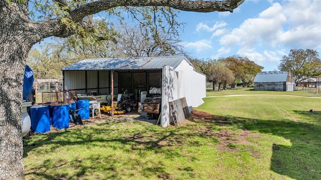 View of pole building with a lawn and a carport | Image 9