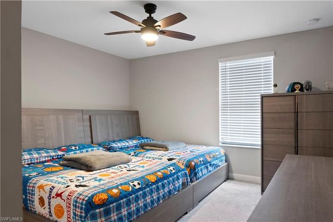 Bedroom featuring multiple windows, baseboards, carpet, and a ceiling fan | Image 32