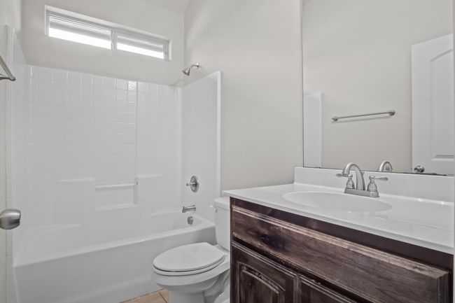 Bathroom with washtub / shower combination, vanity, and toilet | Image 26