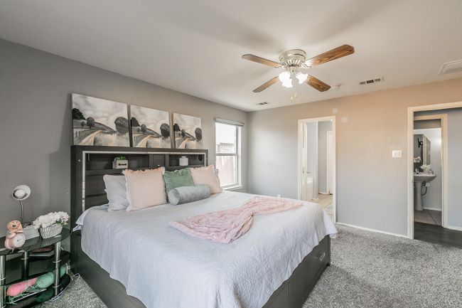 Carpeted bedroom with baseboards and a ceiling fan | Image 20