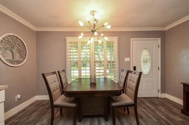 Breakfast/dining area with modern lighting and plantation shutters- lots of natural light! | Image 12