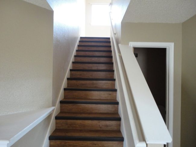 Stairway featuring a textured wall | Image 7