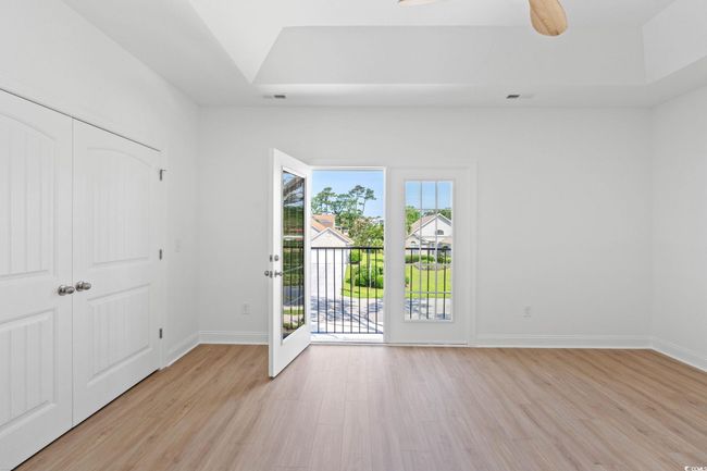 Unfurnished bedroom featuring access to outside, light wood-type flooring, and a closet | Image 12