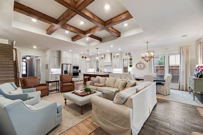 Living area with a chandelier, coffered ceiling, beam ceiling, stairway, and recessed lighting | Image 8