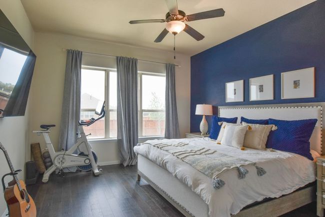 Bedroom featuring baseboards, ceiling fan, and dark wood finished floors | Image 13