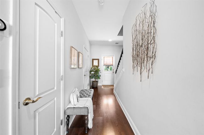 Hallway with baseboards, stairs, and dark wood finished floors | Image 12