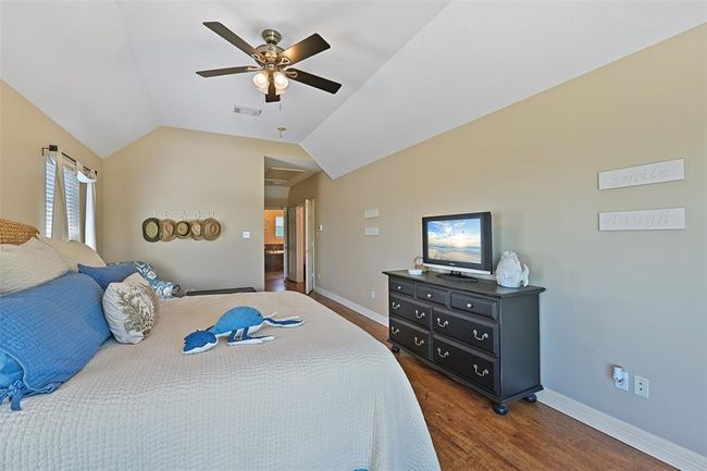 Luxurious primary suite with canal views and a cozy sitting area. | Image 20