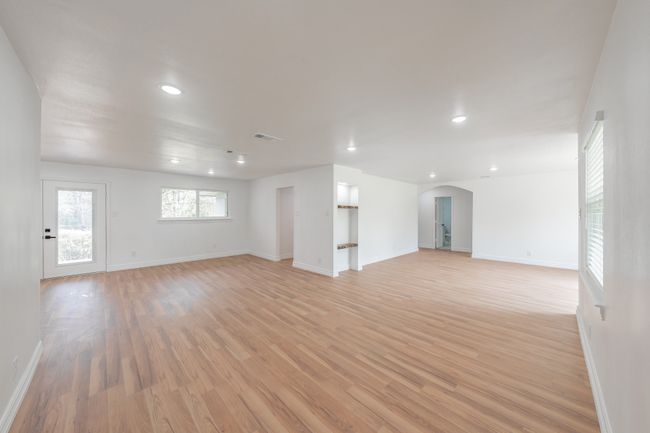 Unfurnished room with arched walkways, light wood-style flooring, recessed lighting, and baseboards | Image 32