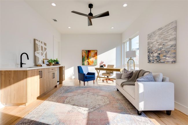 Living room featuring sink, light hardwood / wood-style floors, and ceiling fan | Image 8