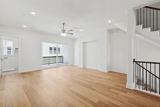Unfurnished living room with light hardwood / wood-style floors and ceiling fan | Image 13