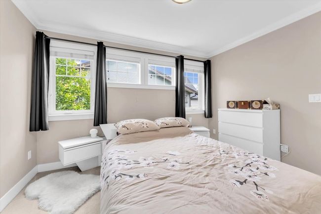 Carpeted bedroom featuring crown molding and baseboards | Image 19