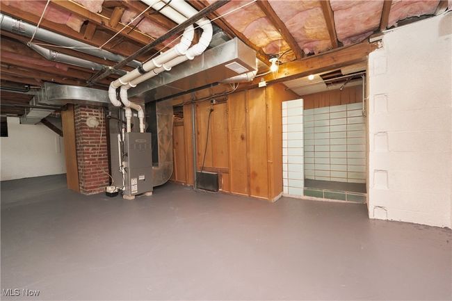 Unfinished basement featuring heating unit | Image 34