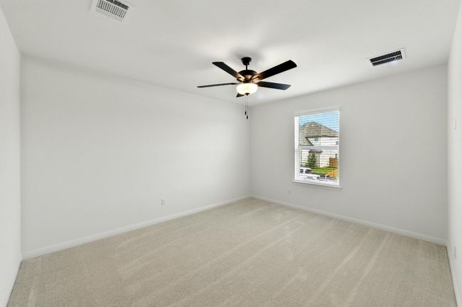 Unfurnished room with light colored carpet, ceiling fan, and baseboards | Image 24