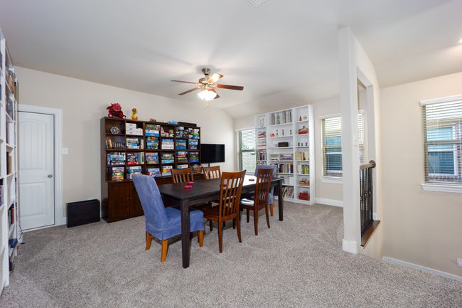 Upstairs game room with a ceiling fan, light carpet, and healthy amount of natural light | Image 11