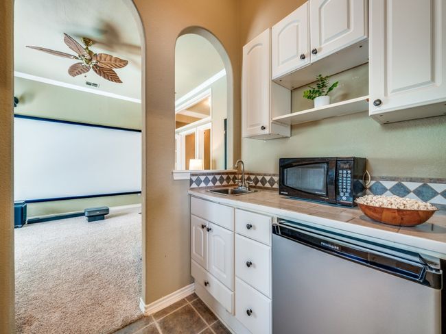Kitchenette with sink and refrigerator for movie nights. | Image 23