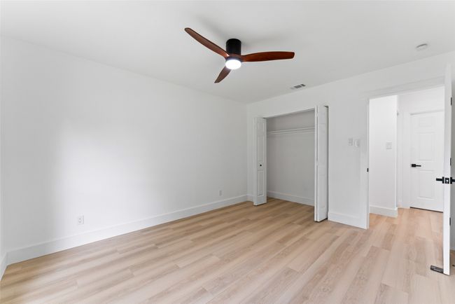 Unfurnished bedroom with light wood-style flooring, a ceiling fan, and a closet | Image 17