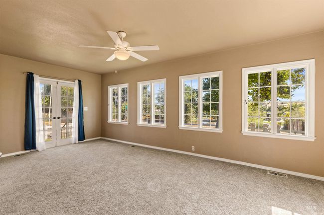 Empty room featuring french doors, carpet flooring, and ceiling fan | Image 24