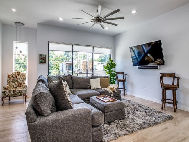 Living room featuring a ceiling fan, light wood-style floors, and recessed lighting | Image 4