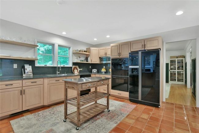 Granite counters, tile floors and plentiful cabinetry make this kitchen a joy to use and also make for easy cleanup. | Image 9