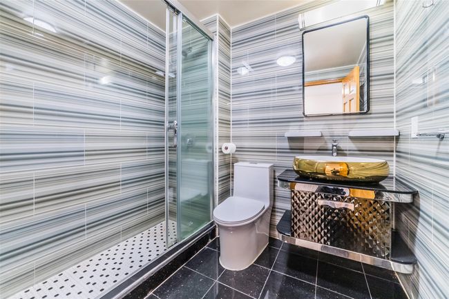 Full bathroom featuring a stall shower and vanity | Image 7